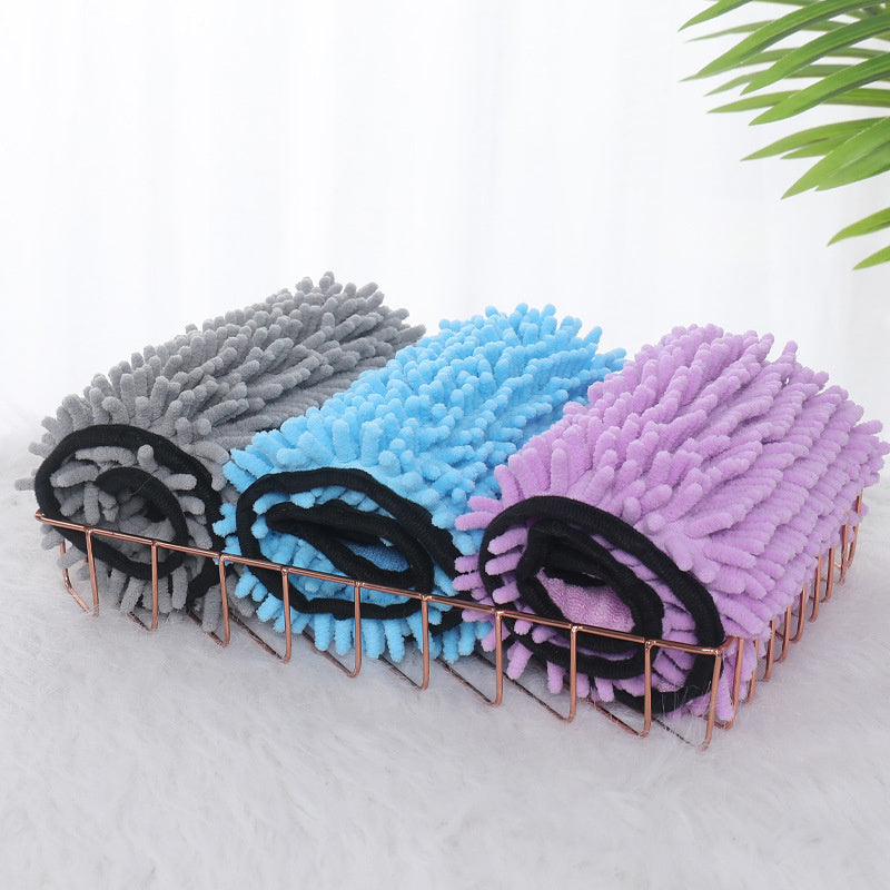 Small dog wrapped in soft absorbent pet towel
